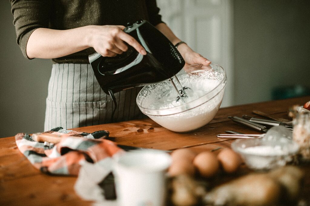 Person whipping cream in a bowl