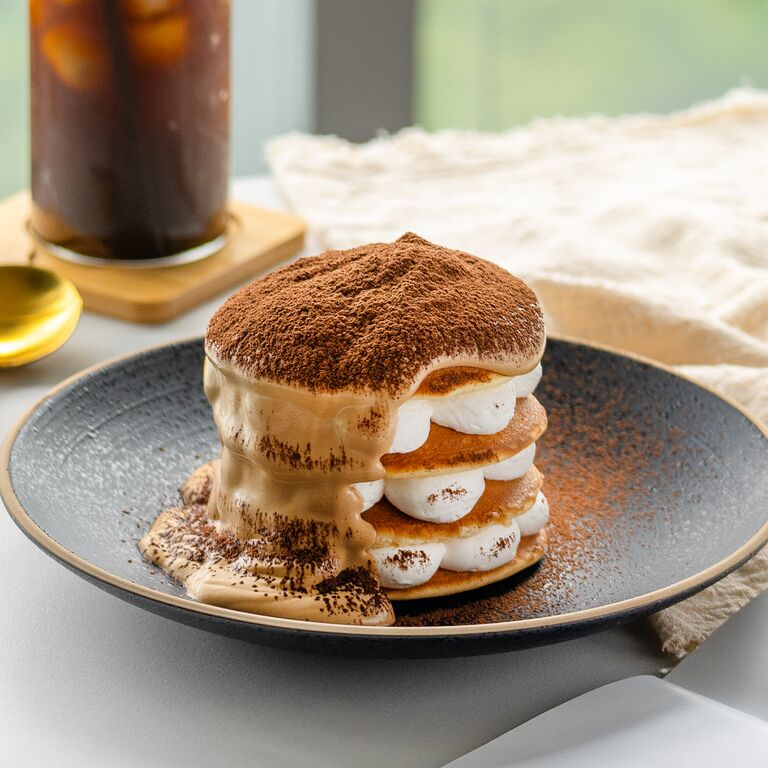 tiramisu dusted with cocoa with iced coffee
