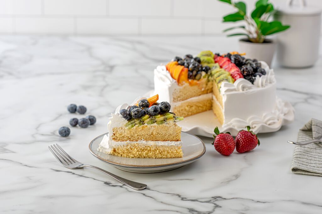 Slice of fresh fruit cream cake