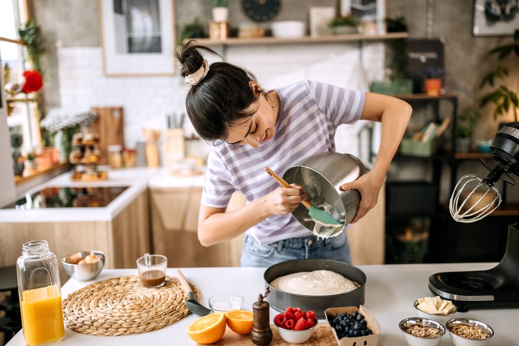 women baking cake in kitchen