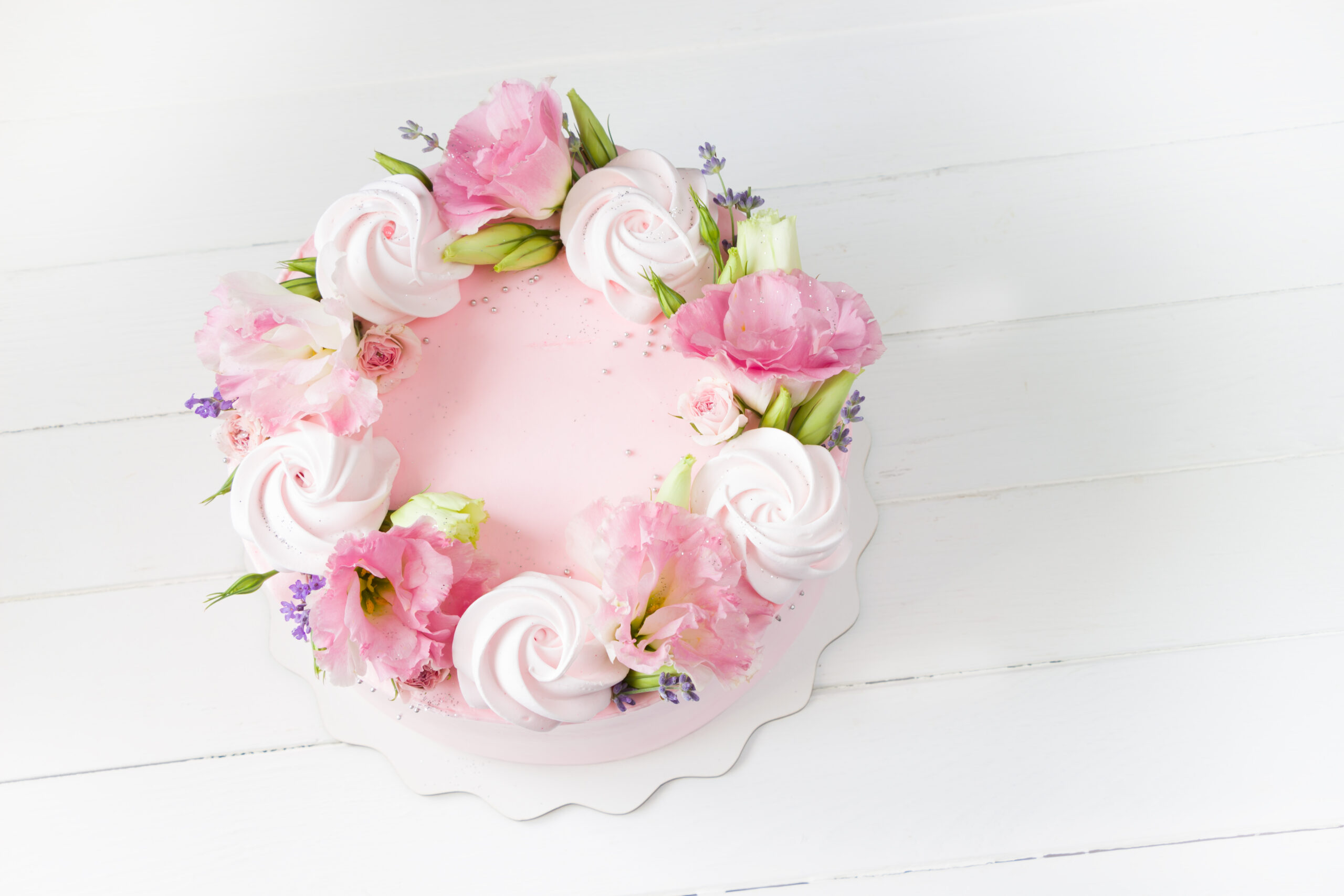 Round pink floral wreath cake with piped buttercream roses