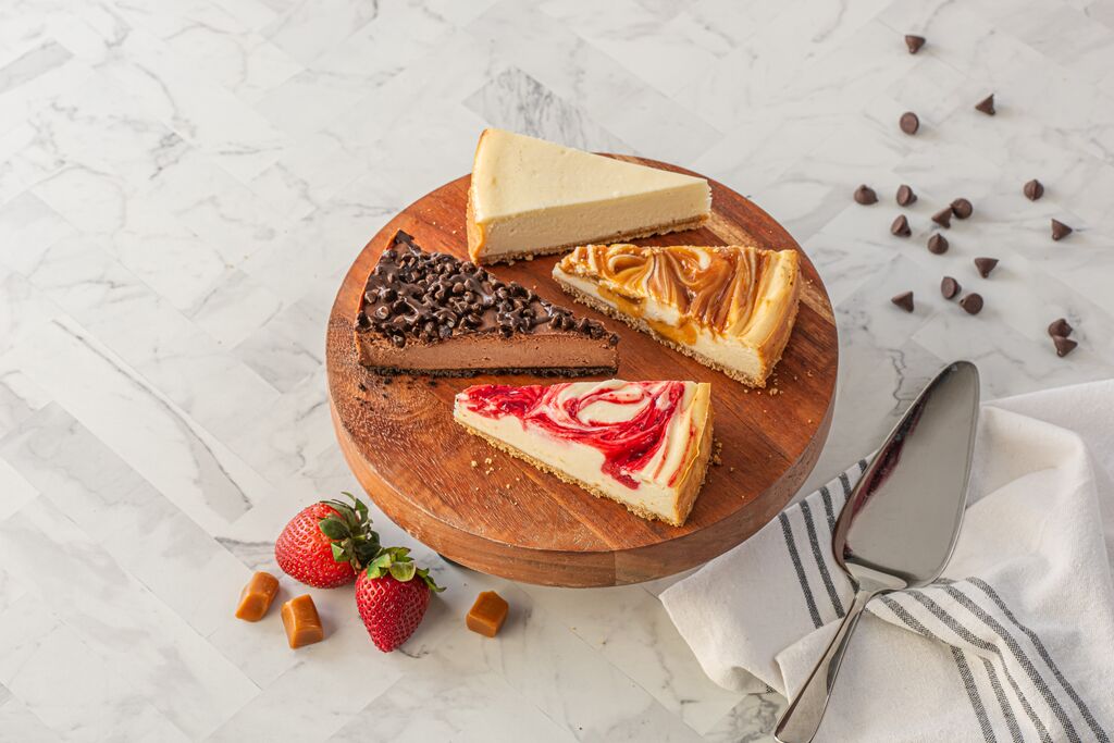 Assorted cheesecake slices on serving board