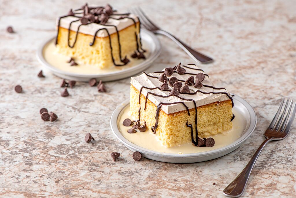 Chocolate cheesecake served on plates with chocolate drizzle and shavings
