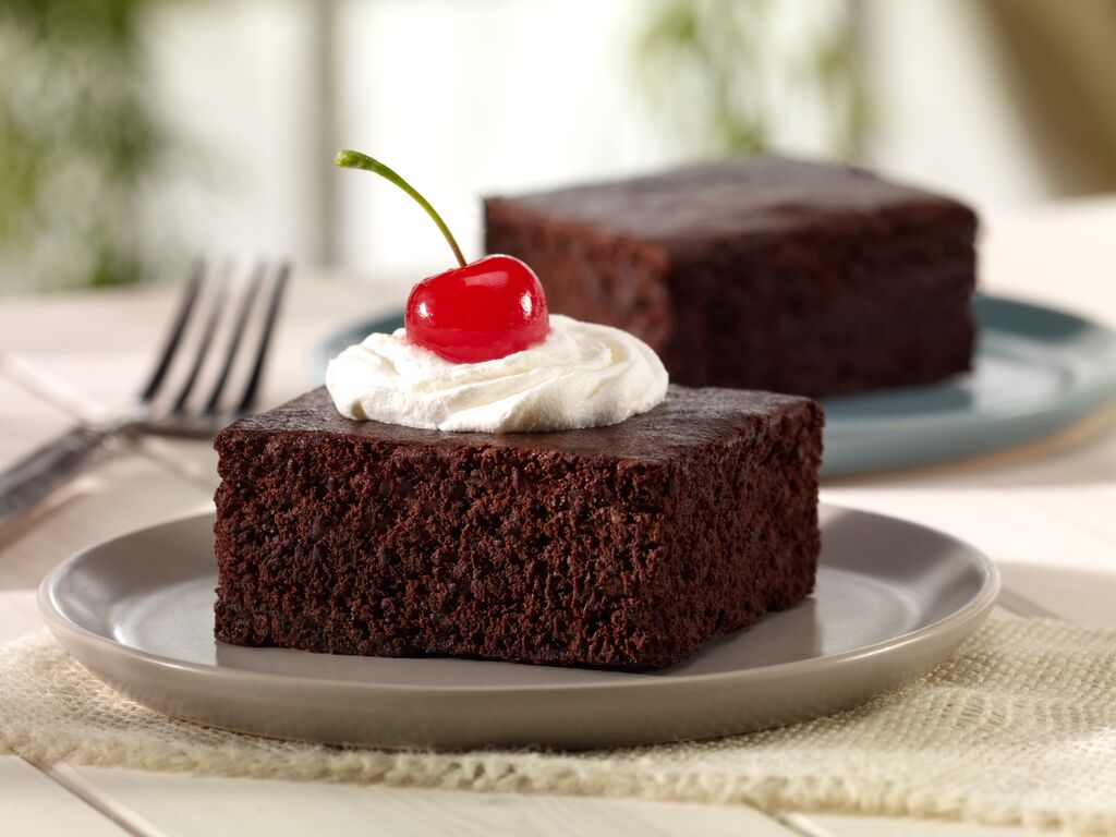 Chocolate cake with whipped cream and cherry