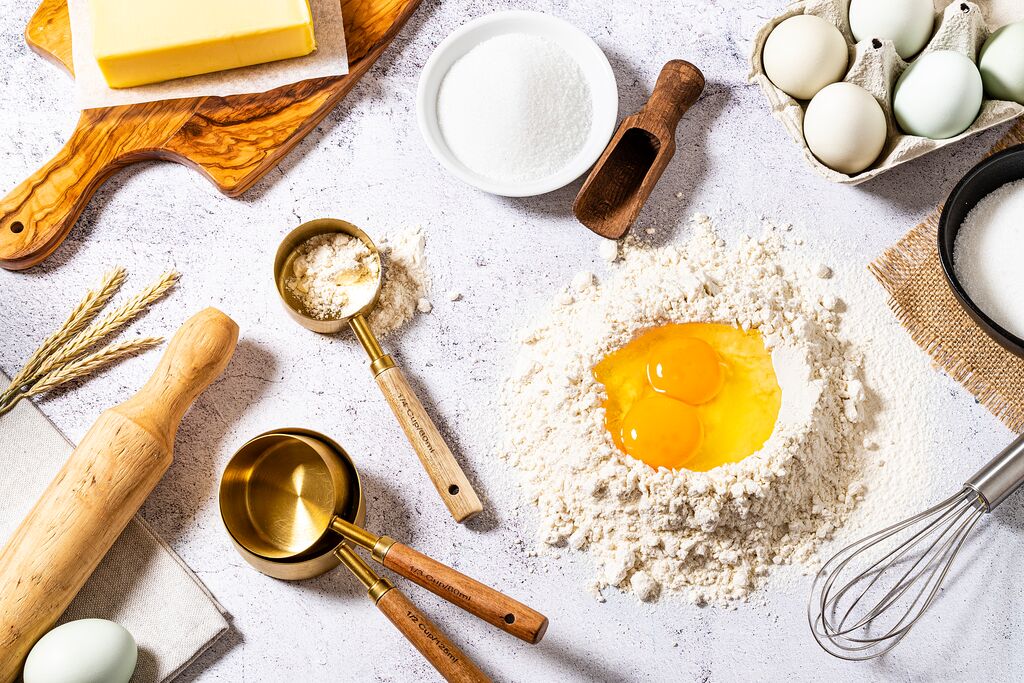 Baking ingredients and utensils arranged on a kitchen counter
