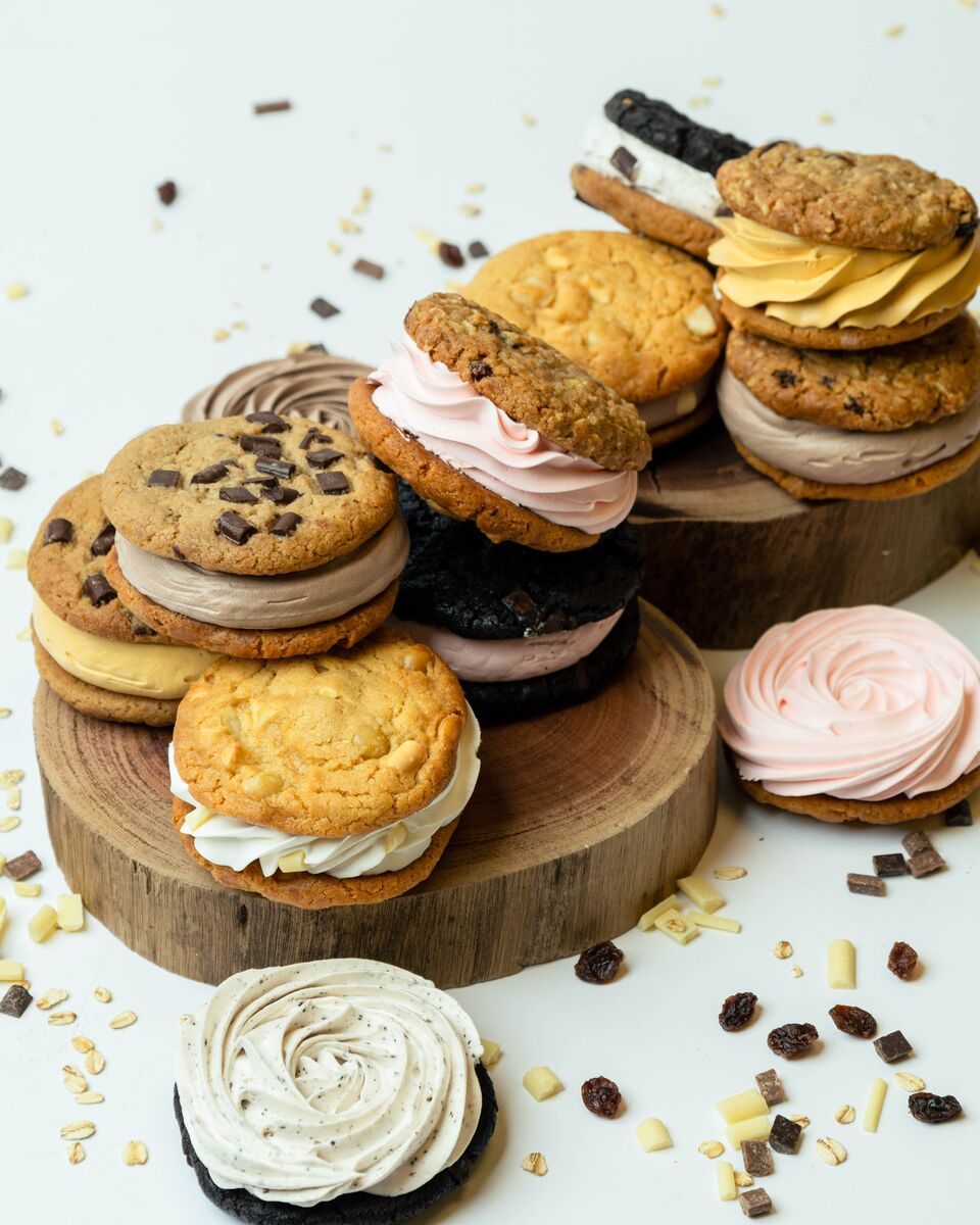 Assorted cookie sandwiches with cream and chocolate fillings.