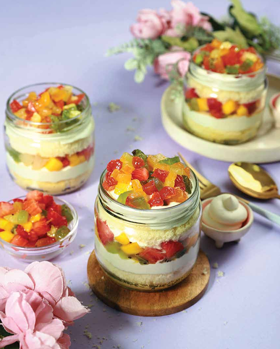 Fruit Bavarian dessert with cream, cake and colourful fruit layers.
