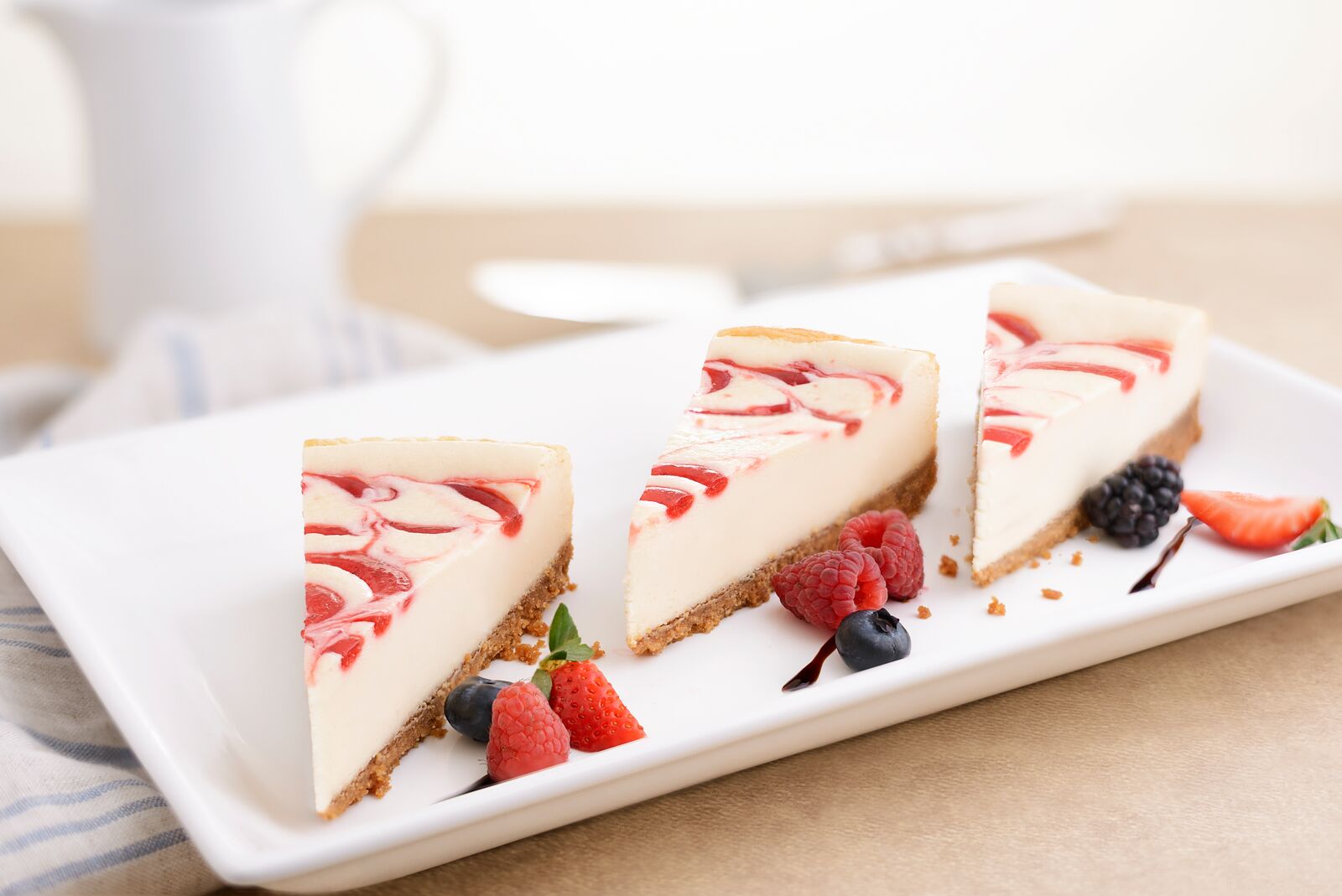 Raspberry swirl cheesecake slices with fresh berries
