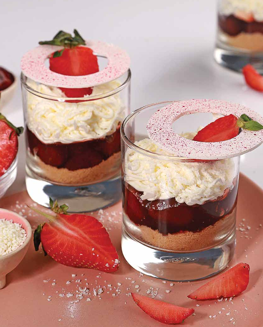 Strawberry vanilla mousse dessert with cream and fresh strawberries.