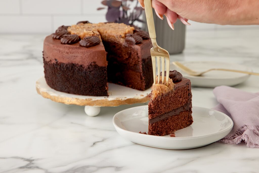 Fork taking a slice of chocolate ganache cake