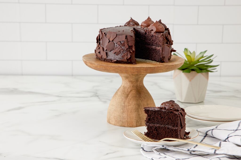 Chocolate ganache cake with chocolate flakes and a served slice
