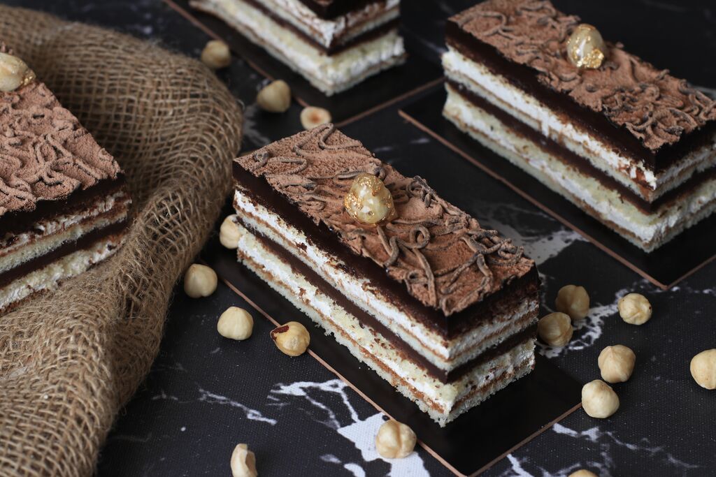 Hazelnut opera cake slices with layered ganache