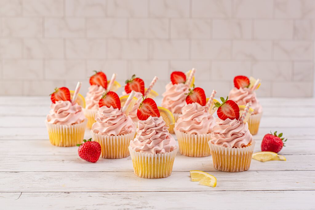 White frosted cake with sprinkle-covered sides that hide uneven frosting