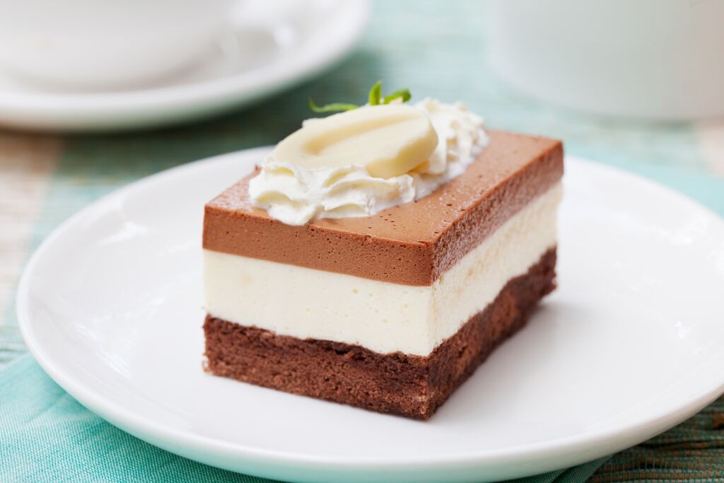 Three-layer chocolate mousse cake with milk, white and dark chocolate layers