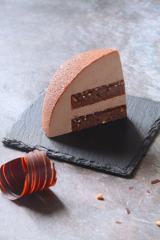Chocolate mousse dessert with a velvet matte finish on a slate board